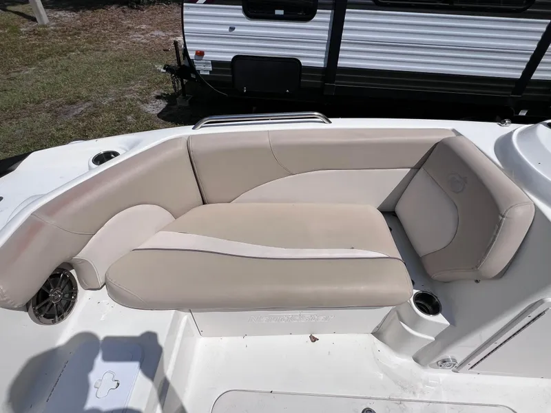 Slide: The Image of 2017 NauticStar 203SC Sport Deck boat with beige seating and cup holders. - 24