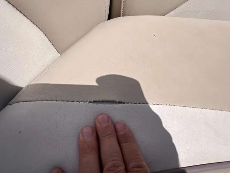 Slide: The Image of Close-up of a 2017 NauticStar 203SC Sport Deck seat with visible seam wear. - 25