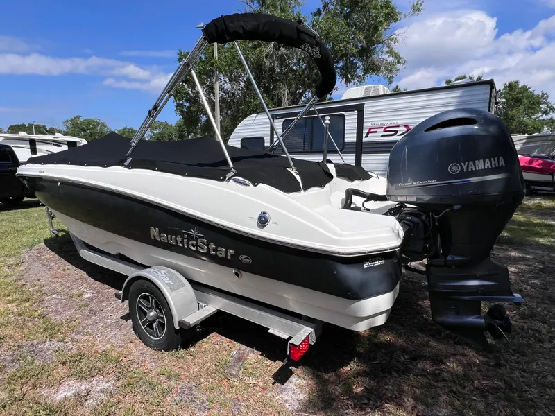 Slide: The Image of 2017 NauticStar 203SC Sport Deck boat with Yamaha engine on trailer. - 3