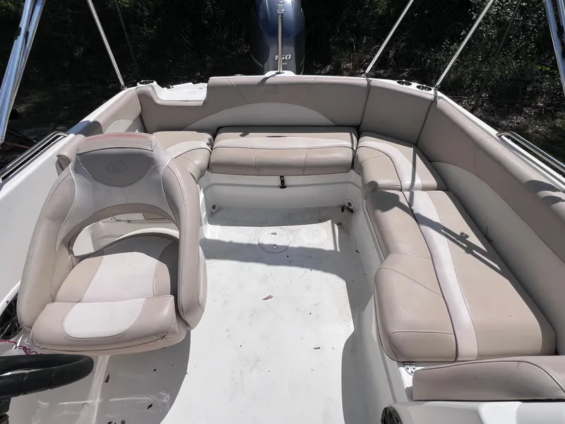 Slide: The Image of 2017 NauticStar 203SC Sport Deck boat interior with beige seating and steering wheel. - 9