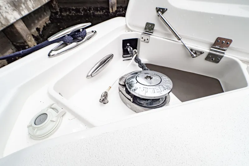 Slide: The Image of 2018 Intrepid 327 Center Console boat anchor compartment with winch and cleat. - 14