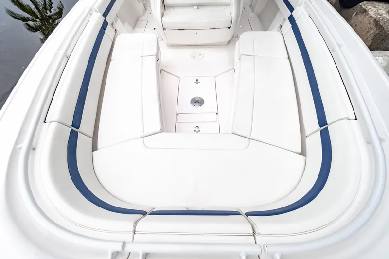 Slide: The Image of 2018 Intrepid 327 Center Console boat interior with white seating and blue accents. - 15