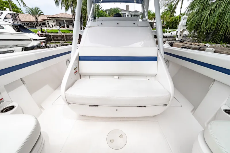 Slide: The Image of 2018 Intrepid 327 Center Console boat interior with white seating and blue accents. - 16