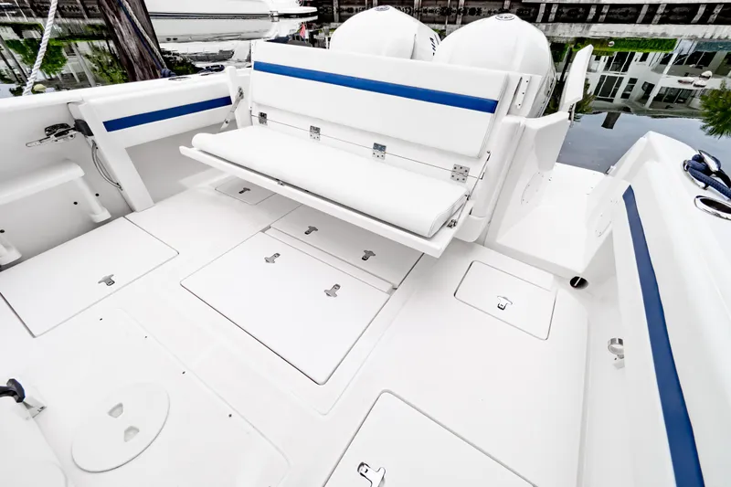 Slide: The Image of 2018 Intrepid 327 Center Console boat with white deck and blue accents. - 2