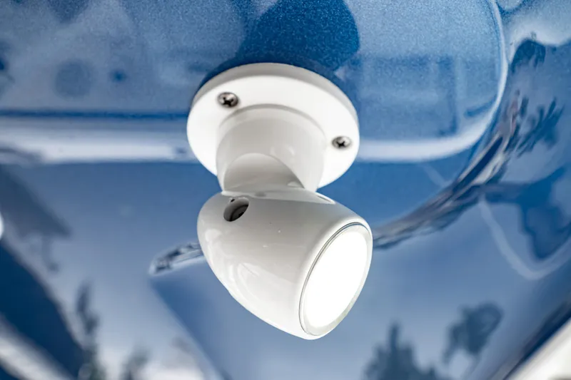 Slide: The Image of White light fixture on 2018 Intrepid 327 Center Console boat, mounted on blue surface. - 21