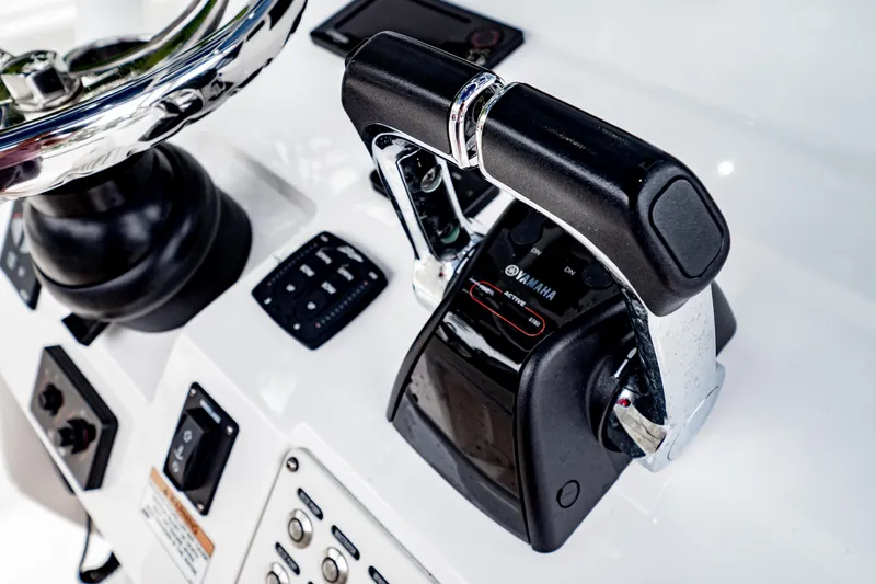 Slide: The Image of 2018 Intrepid 327 Center Console boat controls with Yamaha throttle and steering wheel. - 24