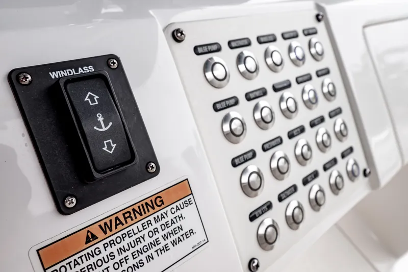 Slide: The Image of Control panel of a 2018 Intrepid 327 Center Console boat with windlass switch and warning label. - 31