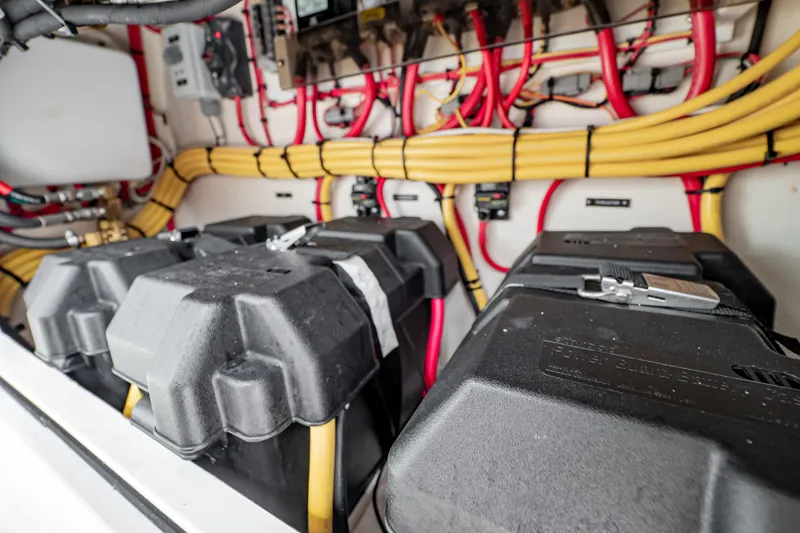 Slide: The Image of 2018 Intrepid 327 Center Console battery compartment with organized wiring and secure battery boxes. - 34