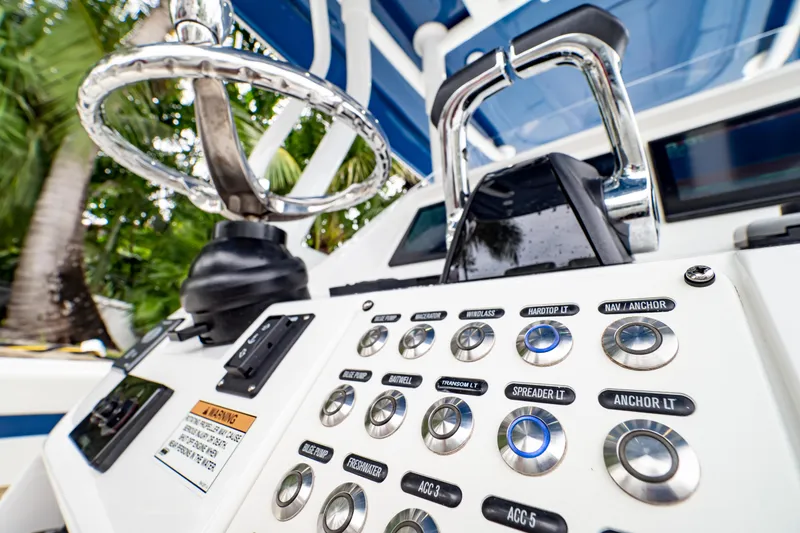Slide: The Image of Control panel of a 2018 Intrepid 327 Center Console boat with various buttons and switches. - 35