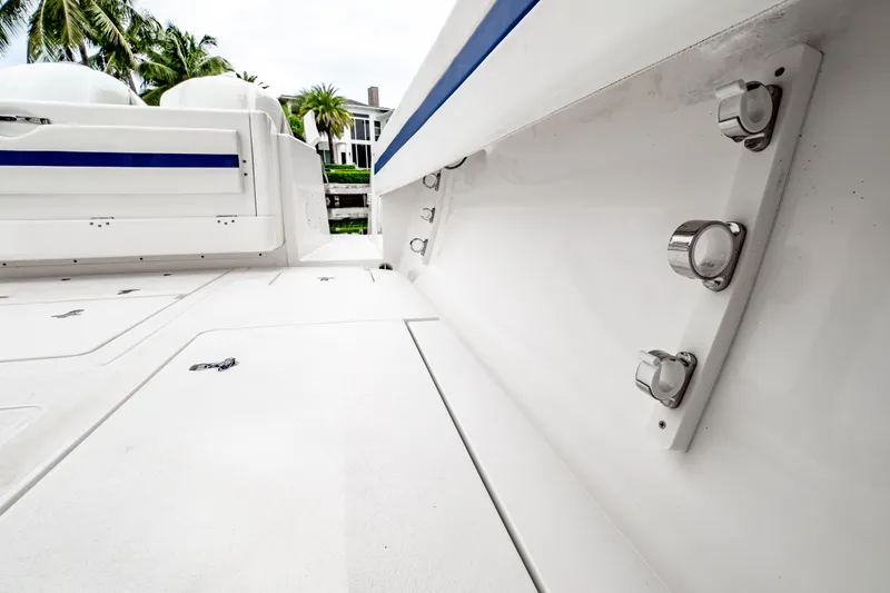 Slide: The Image of 2018 Intrepid 327 Center Console boat deck with rod holders, palm trees in background. - 49