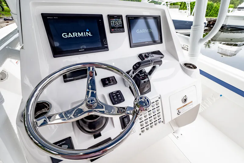 Slide: The Image of 2018 Intrepid 327 Center Console helm with Garmin displays and steering wheel. - 5