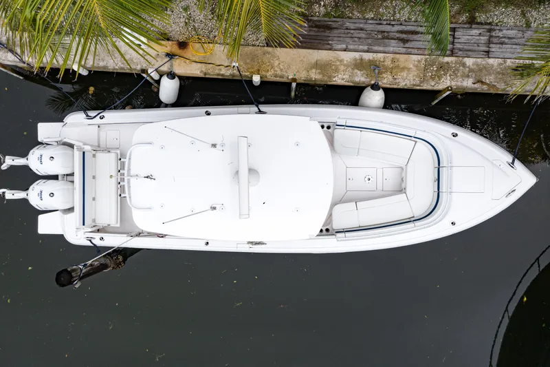 Slide: The Image of Overhead view of a 2018 Intrepid 327 Center Console boat docked by palm trees. - 6