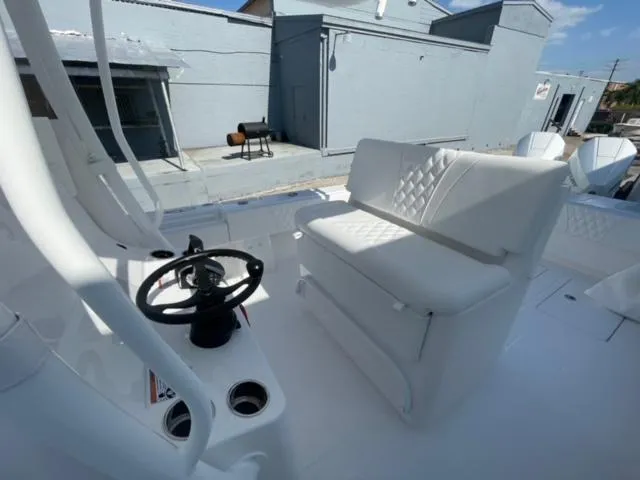 Slide: The Image of 2025 Contender 35 ST boat interior with steering wheel and cushioned seating. - 12