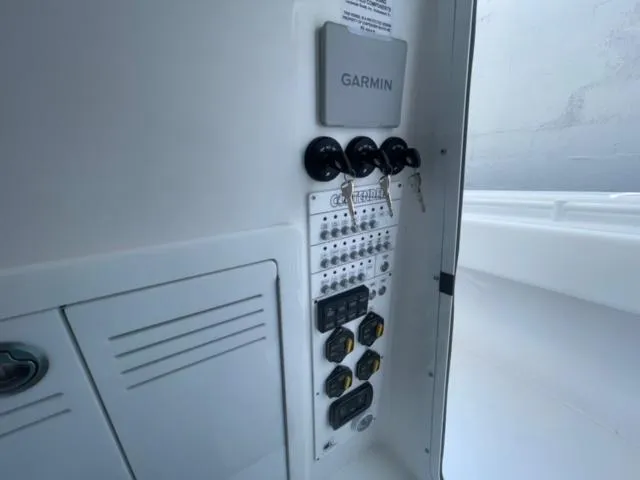 Slide: The Image of Control panel of 2025 Contender 35 ST boat with Garmin system and switches. - 15