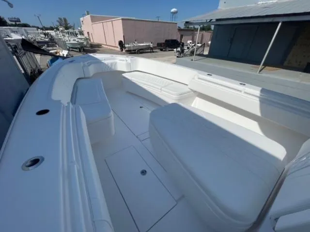 Slide: The Image of 2025 Contender 35 ST boat with spacious seating and sleek design in a marina setting. - 20