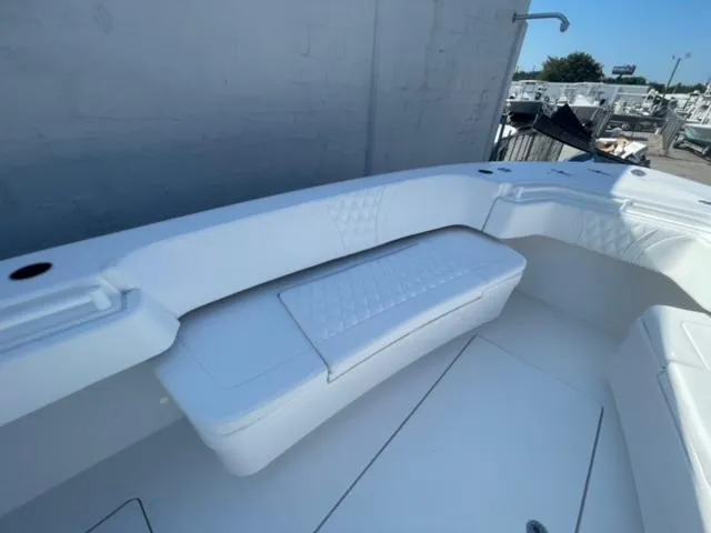 Slide: The Image of 2025 Contender 35 ST boat interior with white cushioned seating and sleek design. - 25