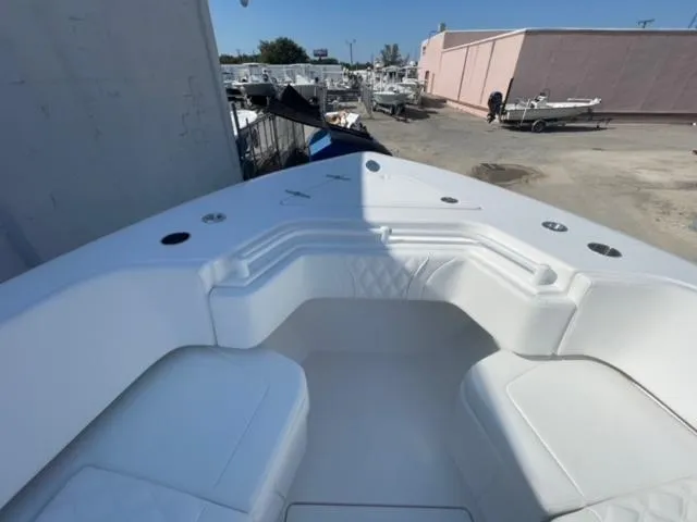 Slide: The Image of 2025 Contender 35 ST boat with white seating, docked in a marina. - 27