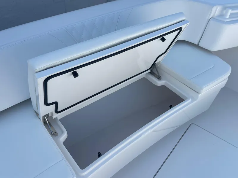 Slide: The Image of Open storage compartment on 2025 Contender 35 ST boat, showcasing sleek white interior design. - 30