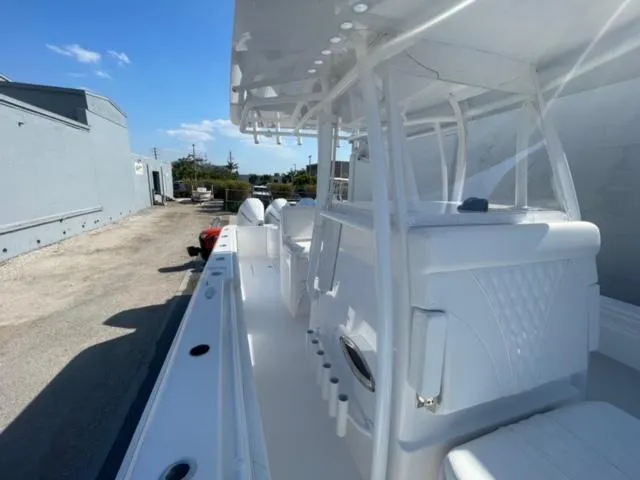 Slide: The Image of 2025 Contender 35 ST boat, white interior, docked outdoors under clear blue sky. - 31