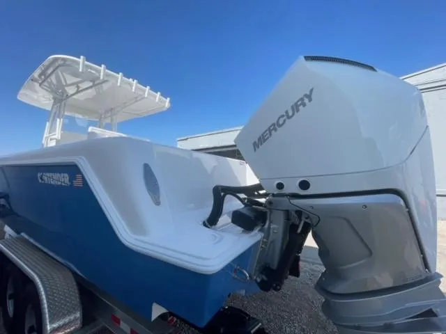 Slide: The Image of 2025 Contender 35 ST boat with Mercury outboard motor, blue and white design. - 4