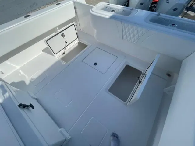 Slide: The Image of 2025 Contender 35 ST boat interior with open storage compartments and clean white finish. - 7