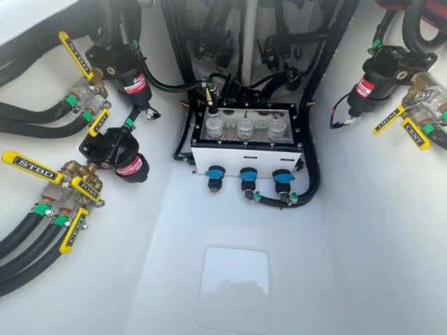 Slide: The Image of 2025 Contender 35 ST boat engine compartment with fuel lines and valves. - 8
