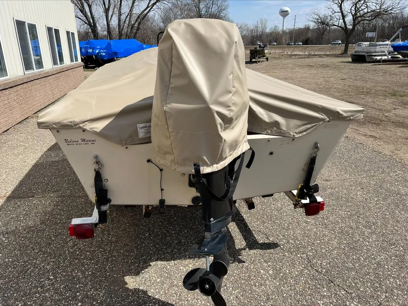 Slide: The Image of 2000 Alumacraft V 16 LTD boat with cover, parked outdoors on a sunny day. - 10