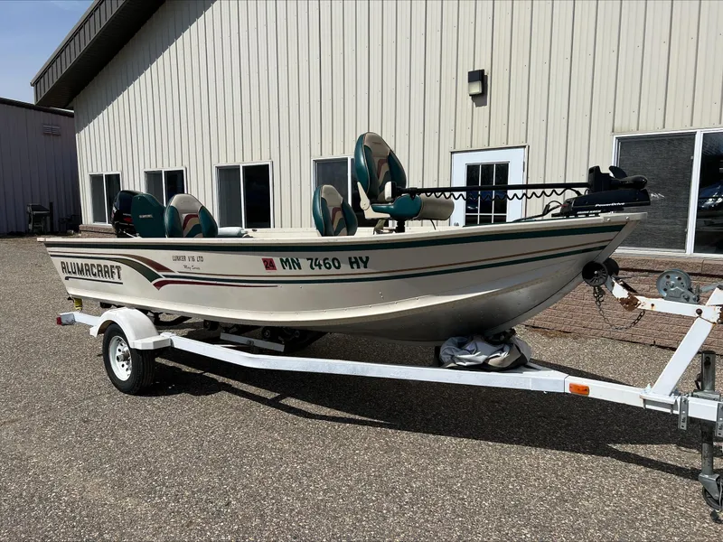 Slide: The Image of 2000 Alumacraft V 16 LTD boat on trailer, parked outside a building. - 4