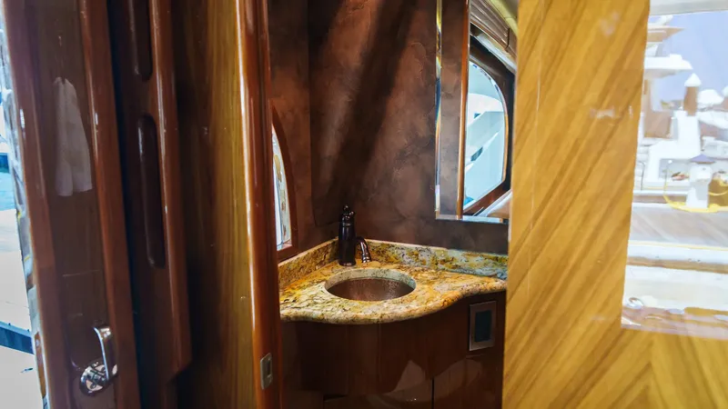 Slide: The Image of Luxurious bathroom interior on 2012 Viking 70 Enclosed Bridge yacht with granite countertop. - 20