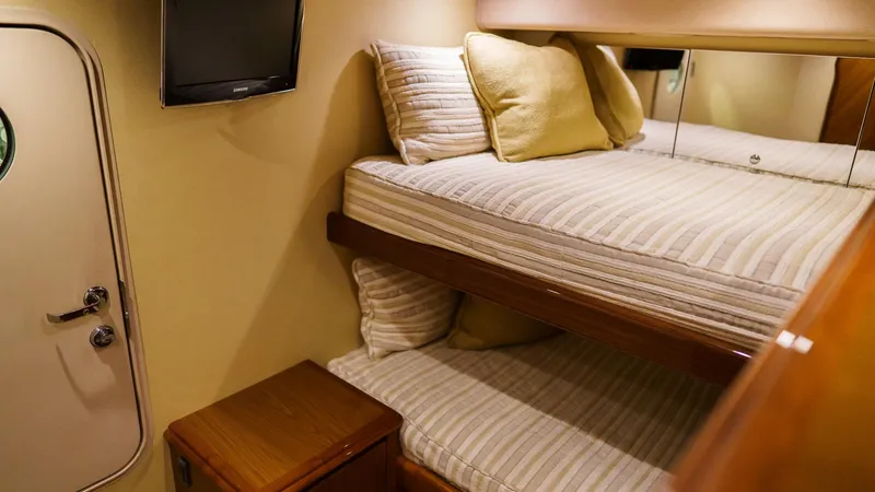 Slide: The Image of Interior of 2012 Viking 70 Enclosed Bridge yacht with cozy bunk beds and TV. - 41