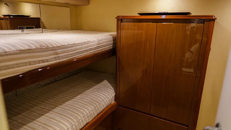Slide: The Image of Bunk beds and wooden cabinet in 2012 Viking 70 Enclosed Bridge yacht interior. - 43