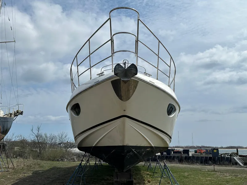 Slide: The Image of 2008 Azimut 62 Evolution yacht on land, front view under cloudy sky. - 10