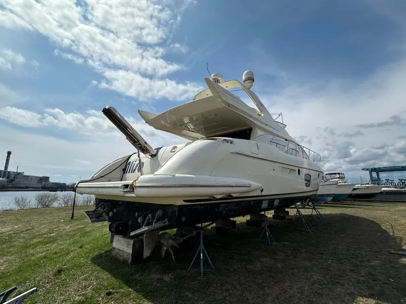 Slide: The Image of 2008 Azimut 62 Evolution yacht on land under a partly cloudy sky. - 12