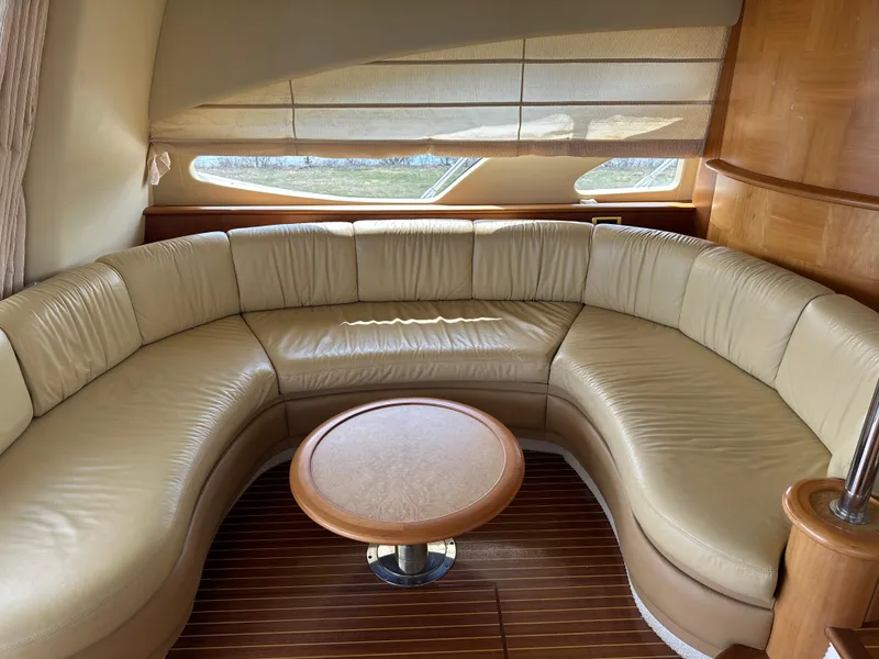 Slide: The Image of Luxurious interior of 2008 Azimut 62 Evolution yacht with curved leather seating and wooden table. - 13