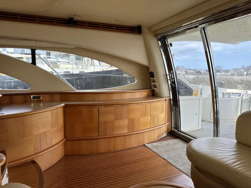 Slide: The Image of Luxurious interior of a 2008 Azimut 62 Evolution yacht with wooden cabinetry and large windows. - 14