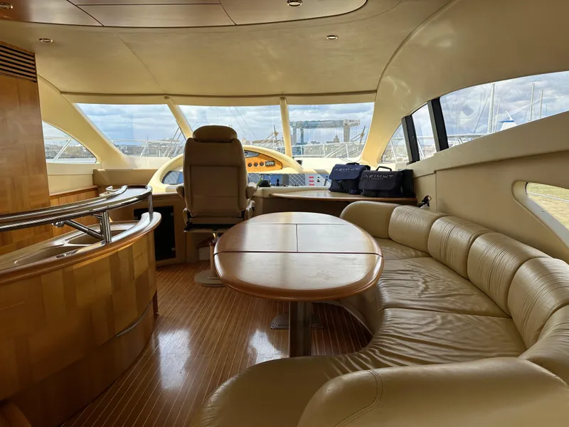 Slide: The Image of Luxurious interior of a 2008 Azimut 62 Evolution yacht with leather seating and wooden finishes. - 15