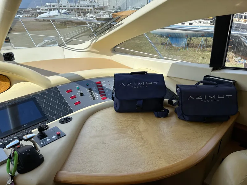 Slide: The Image of 2008 Azimut 62 Evolution yacht helm with control panel and branded bags. - 20