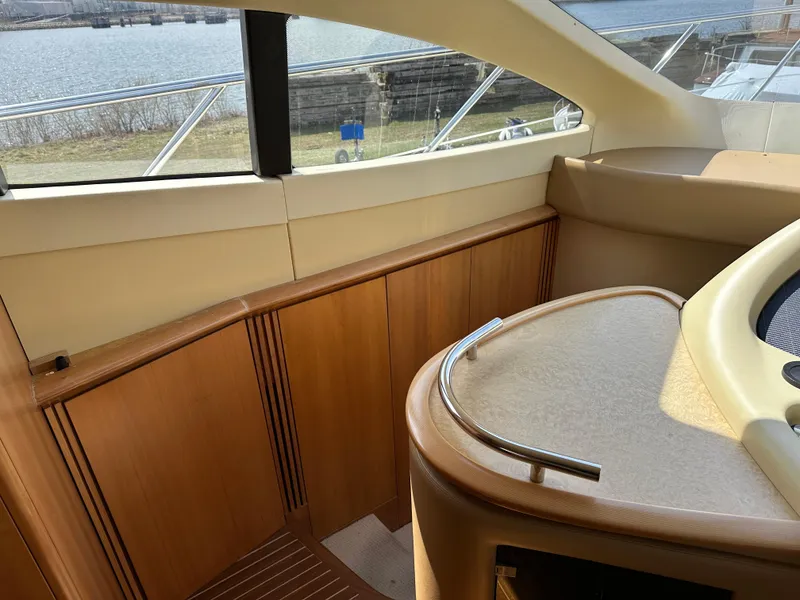 Slide: The Image of Interior view of 2008 Azimut 62 Evolution yacht with wooden cabinetry and window. - 21