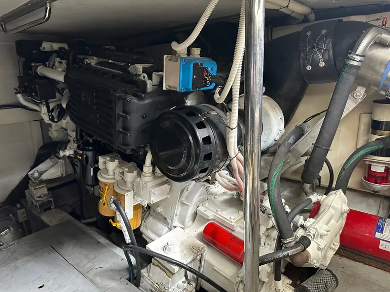 Slide: The Image of Engine room of a 2008 Azimut 62 Evolution yacht, showcasing mechanical components and wiring. - 25