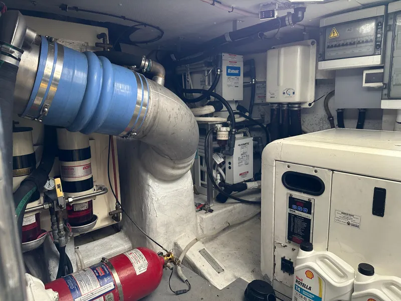 Slide: The Image of Engine room of a 2008 Azimut 62 Evolution yacht, featuring mechanical components and safety equipment. - 30