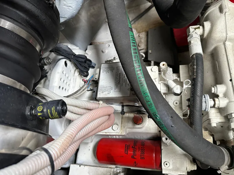 Slide: The Image of Engine compartment of a 2008 Azimut 62 Evolution yacht, showing hoses and components. - 31