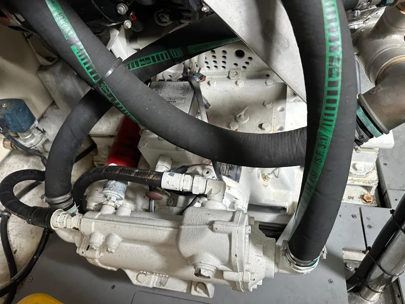 Slide: The Image of Engine compartment of a 2008 Azimut 62 Evolution yacht, featuring hoses and mechanical components. - 32