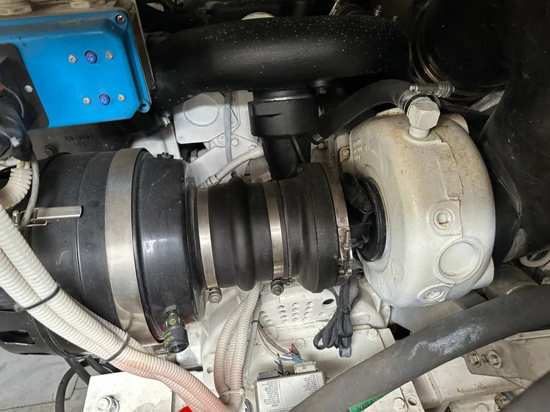 Slide: The Image of Engine component of a 2008 Azimut 62 Evolution yacht, featuring hoses and mechanical parts. - 35