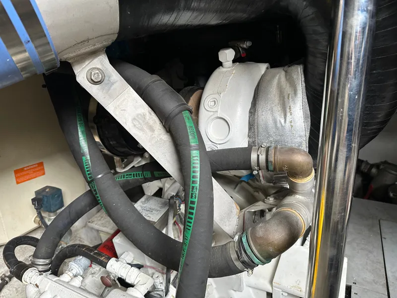 Slide: The Image of Engine compartment of a 2008 Azimut 62 Evolution yacht, featuring hoses and mechanical components. - 36