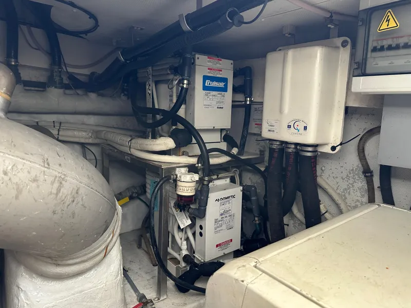 Slide: The Image of Engine room of a 2008 Azimut 62 Evolution yacht, featuring mechanical equipment and piping. - 39