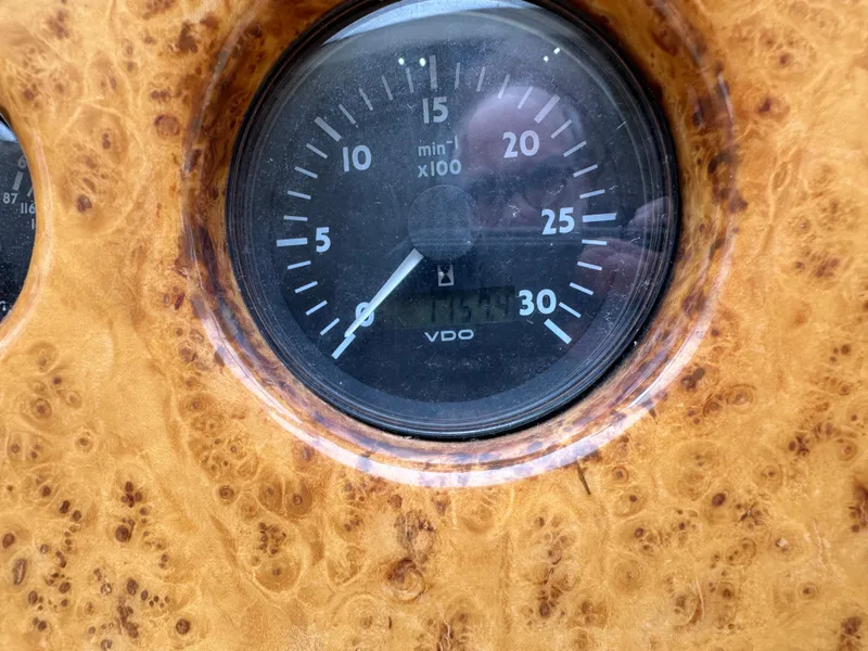 Slide: The Image of Close-up of a 2008 Azimut 62 Evolution boat tachometer on a wooden dashboard. - 44