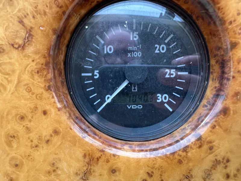 Slide: The Image of Close-up of a 2008 Azimut 62 Evolution tachometer on a wooden dashboard. - 45