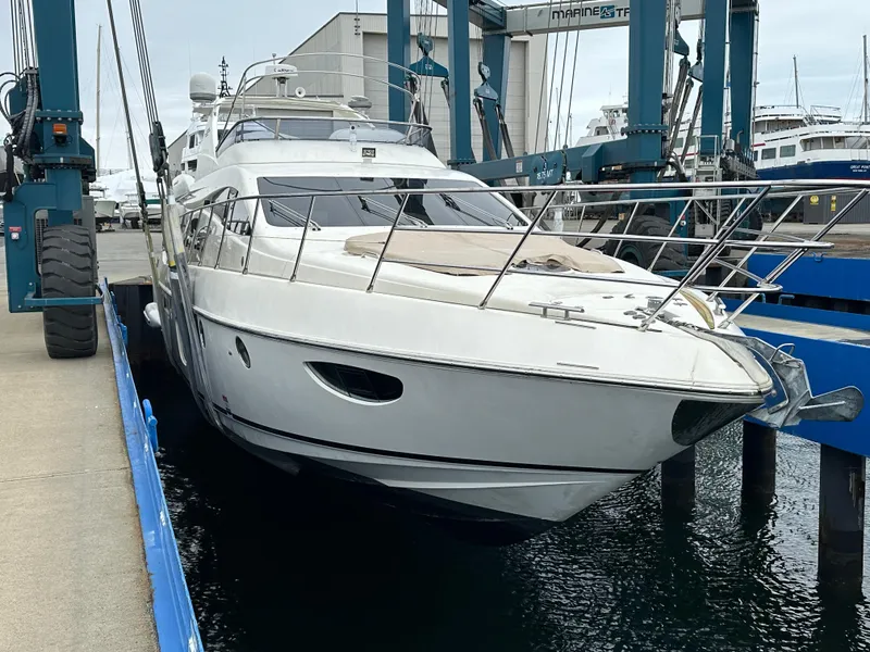 Slide: The Image of 2008 Azimut 62 Evolution yacht docked at a marina, showcasing sleek design and luxury features. - 8