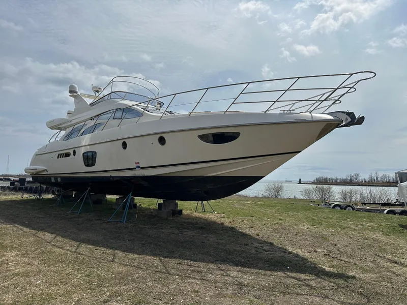 Slide: The Image of 2008 Azimut 62 Evolution yacht on land, side view, under cloudy sky. - 9