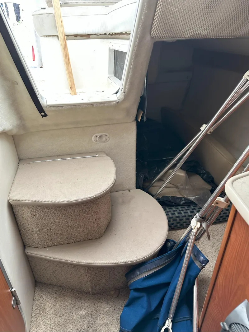 Slide: The Image of Interior view of 2005 Bayliner 245 CIERA boat, featuring steps and cabin entrance. - 10